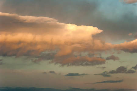 Blue sky with golden clouds at sunset. Natural backgroundの写真素材