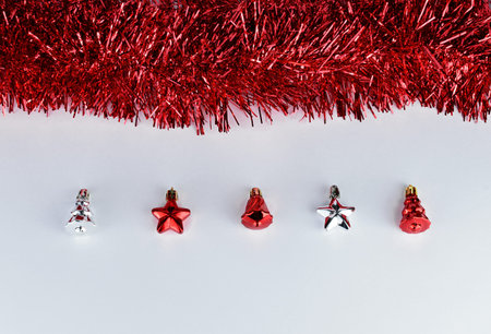 Christmas silver toys in a glass goblet on a black background