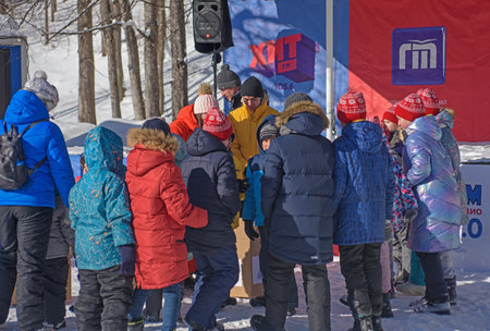 RUSSIA, YAROSLAVL - FEBRUARY 22, 2021. Winter holiday Dad's Day in the forest entertainment Park Zabava - the presenter holds contests among spectators of children and parentsのeditorial素材
