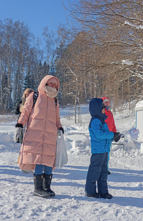 RUSSIA, YAROSLAVL - FEBRUARY 22, 2021. Winter holiday Dad's Day in the forest amusement Park Fun - people, participants of the holiday, spectators, boys and girls, teenagersのeditorial素材