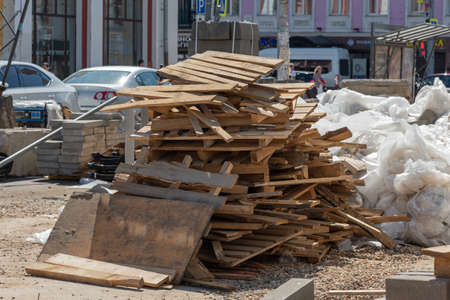Dump of wooden boards, waste, bags and garbage on the main street of the city, road repairの写真素材