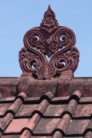 red metal tile roof and stucco on blue sky