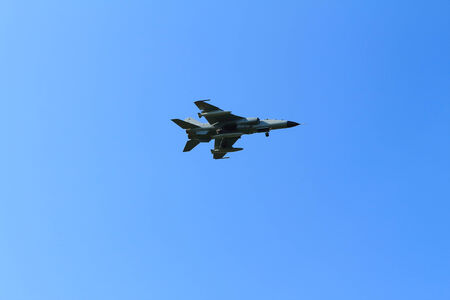The plane flies against the blue skyの写真素材