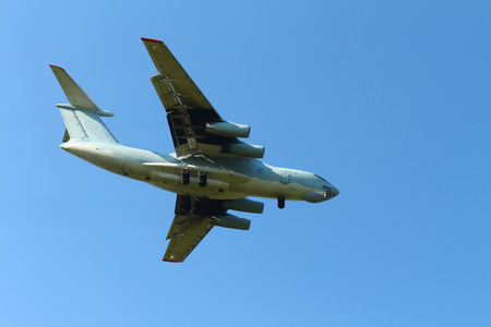 The plane flies against the blue skyの写真素材