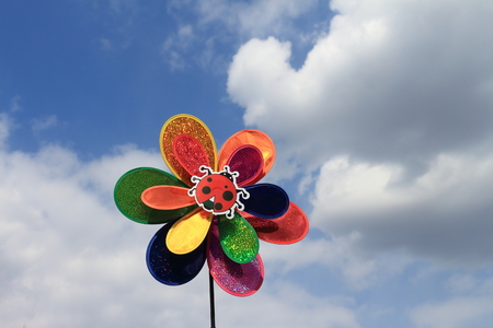Ornament in the form of a ladybug on a flower against the sky の写真素材