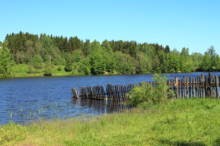 The flooded fence during a spring high water on the riverの写真素材