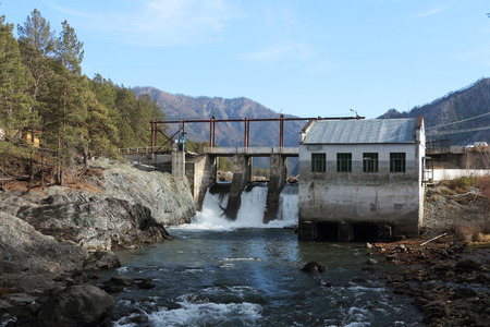 The old hydroelectric power station on the river Chemal after a flood in mountain Altai in Russiaの写真素材