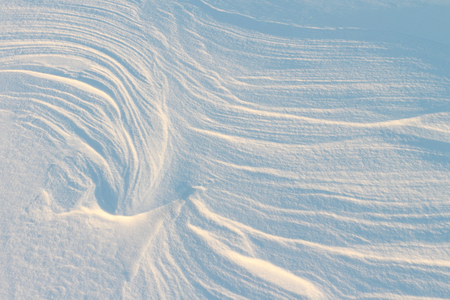 Snow on the frozen river in the winter at sunsetの写真素材