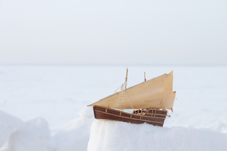The toy sailing schooner standing on snow in the winter outdoorsの写真素材