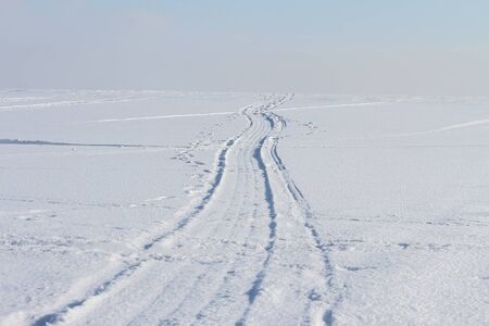 The twisting road on the snow-covered river in the winterの写真素材