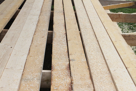 Construction of a floor from pine boards on a veranda outdoors
