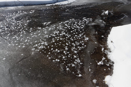 Formation of hoarfrost on thin ice of the thawing river in the spring