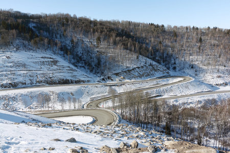 Mountain  highway among snow slope , Belokurikha,  Altai, Russia