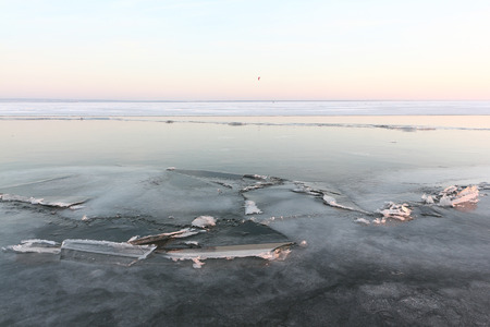 Cracks with ice crystals on frozen river at sunset, Ob reservoir, Siberia, Russiaの写真素材