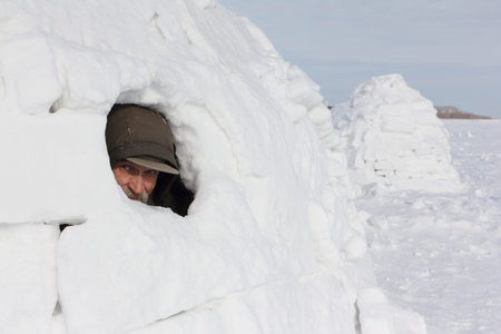 Head of a man sitting in an igloo in winter