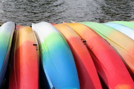 Colored canoes near the water on the pierの写真素材