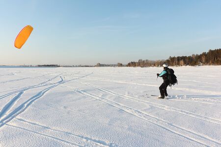Man is engaged in snowkiting on a frozen reservoir, Novosibirsk, Russiaの写真素材