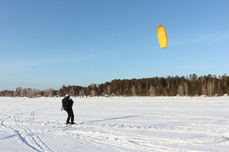 Man training in snow kiting on frozen reservoir, Novosibirsk, Russiaの写真素材
