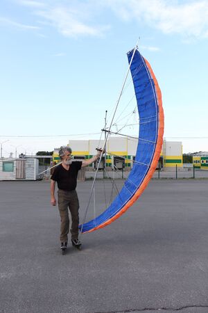 Man training in roller skating with a kite, Novosibirsk, Russiaの写真素材