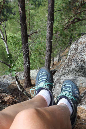 Women's feet in trekking boots on the top of a mountain, Altai Mountains, Russiaの写真素材