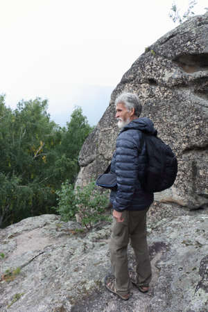 Man climbing a rock, Ambarchiki rocks, Altai mountains, Belokurikha 2, Russiaの写真素材