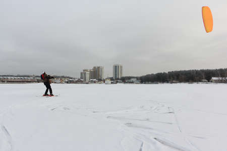 Man practicing snowkiting on the snowy surface of the Ob reservoir, Novosibirsk, Russiaの写真素材
