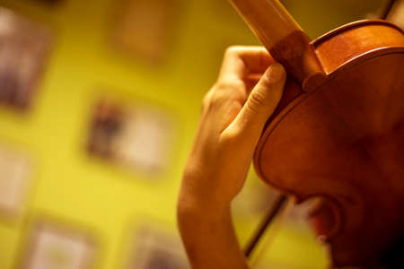 blurry left hand of a young violinist presses the strings on the violin neck, horizontalの写真素材
