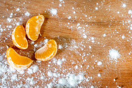 festive christmas background with tangerine slices on wooden surface, new year, topの写真素材