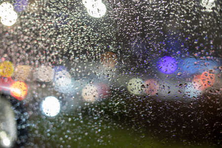 abstract blurred background on the windshield of a car during a traffic jam in the rainの写真素材