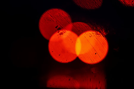 blurred abstract background reflection of drops on the windshield of a car in heavy rain when the...