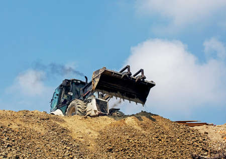 worker operates an escalator on a sunny hot day. global construction. Mining, saltの写真素材