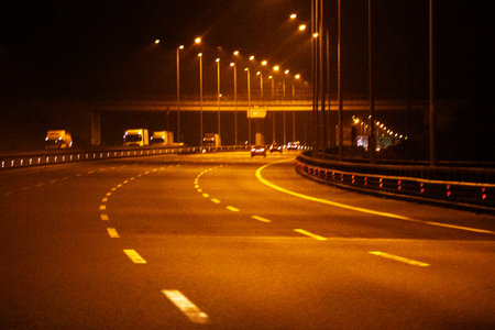 blurred night road in traffic with cars at the junction. night city.の写真素材