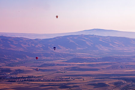 beautiful view of the flight of hot air balloons in the early morning in the valley of Goreme...