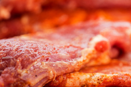 sliced ââpieces of raw pork meat with seasonings on the board. close up. flat layの写真素材