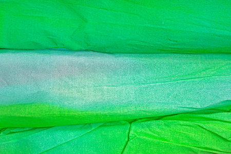 abstract green background from corrugated paper with gradient and rolls, horizontal