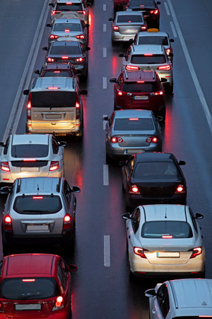 traffic jam in the city in bad rainy weather in the evening, top view, verticalの写真素材