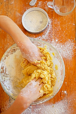 cook cookies draw a heart from flour on the table with your hands. preparation for the holiday.の写真素材