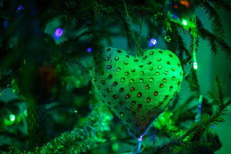 green heart with beads at night green lighting with lanterns, horizontal formatの写真素材