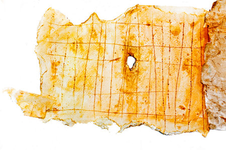 imitation of old paper with spots, a hole in the middle and torn edges