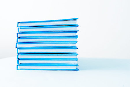 stack of blue books on a white backgroundの写真素材