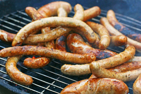 grilled delicious hot sausages on the grill blurの写真素材
