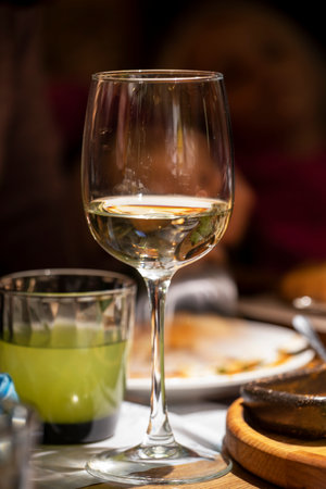 glass with drink and glass with lemonade on festive dark blurred background, verticalの写真素材