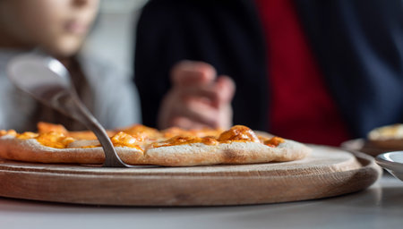 hot pizza on a wooden board close-up, horizontal