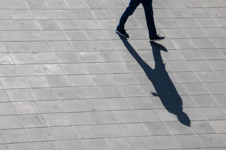 conceptual photography shadow from a guy on a pavement, top view, horizontal