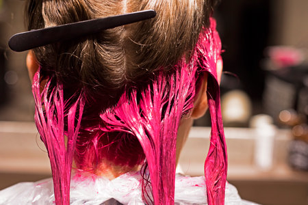 close-up of the back of the head of the dyed strands of blond hair in a bright pink color, beauty salonの写真素材