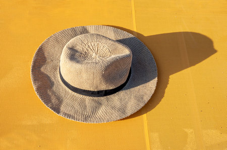 beach hat on a yellow background illuminated by the sun, horizontalの写真素材