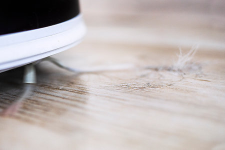 close-up robot vacuum cleaner automatic cleaning wool house. horizontalの写真素材