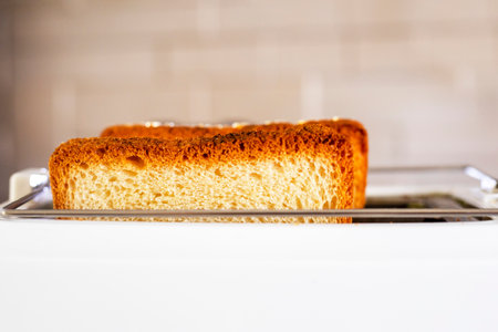 close-up of two ready toasted slices of bread in the toaster in the kitchen. Horizontalの写真素材