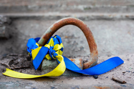 blue-yellow ribbon tied to the weapon. War with Ukraineの写真素材
