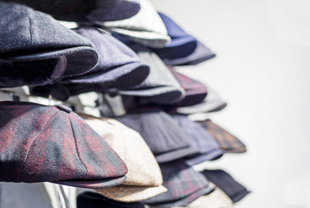 Traditional men's wool tweed caps are for sale. Horizontal